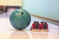 Close-up colorful bowling balls and bowling pins and bowling shoes on the bowling track. Royalty Free Stock Photo