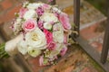 Close up of a colorful bridal bouquet on bricks