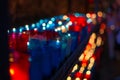 Close up of colorful candles in a dark spiritual scene. Commemoration, funeral, memorial. Religious symbolism