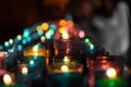 Close up of colorful candles in a dark spiritual scene. Commemoration, funeral, memorial. Religious symbolism