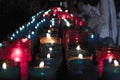 Close up of colorful candles in a dark spiritual scene. Commemoration, funeral, memorial. Religious symbolism