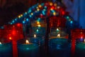 Close up of colorful candles in a dark spiritual scene. Commemoration, funeral, memorial. Religious symbolism