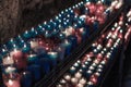 Close up of colorful candles in a dark spiritual scene. Commemoration, funeral, memorial. Religious symbolism