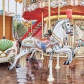 Close-up the colorful carousel horses in a retro style. The amusement park