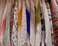 Close up of colorful cloths and scarfs hanging for sale in the medina of Marrakech, Morocco.