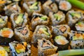 Close-up on a colorful collection of selfmade Sushi rolls on a wooden board