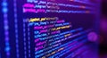 Close up of colorful computer code displayed on a dark screen with purple hues Royalty Free Stock Photo