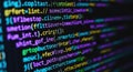 Close-up of colorful computer code glowing on a digital screen with a blurry background Royalty Free Stock Photo