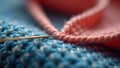Close-up of colorful crochet work with needle in pink and blue yarn Royalty Free Stock Photo