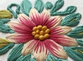 Close-up of a colorful embroidered flower with detailed stitches on fabric