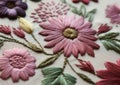 Close-up of a colorful embroidered flower with detailed stitches on fabric