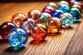 close-up of colorful glass marbles on a wooden surface