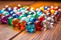 close-up of colorful glass marbles on a wooden surface