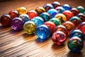 close-up of colorful glass marbles on a wooden surface