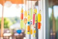 close-up of colorful glass wind chimes hanging on porch Royalty Free Stock Photo