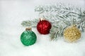 Glittery Christmas ornaments in snow