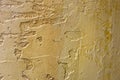 Close-up of colorful golden bronze plastered uneven stucco wall. Abstract texture, chaotic copy space background. Decorative Royalty Free Stock Photo