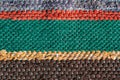 Close up of a colorful handmade motley striped rug or carpet of different colors - red, green, yellow and brown Royalty Free Stock Photo