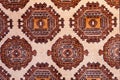 Close-up of colorful handmade silk carpet with pattern in red tones, traditional uzbekistan style.