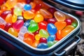 close-up of colorful jelly beans in a small lunchbox