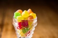 Close up colorful liquor sweets in a glass on wooden table