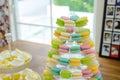 Close-up colorful macarons on pyramid-shaped plastic stand