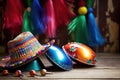 close-up of colorful maracas and sombrero on a rustic wooden table