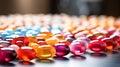 Close up of colorful pills on reflective surface. Focus on foreground