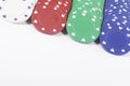 Close up on colorful poker chips over white