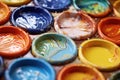 close-up of colorful pottery glazes on palette