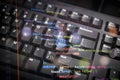 Close-up of colorful programming code overlay on black keyboard, representing modern software development, coding, and digital Royalty Free Stock Photo