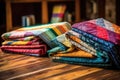 close-up of colorful quilt patterns on a wooden table