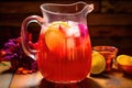 close-up of colorful rum punch in glass pitcher