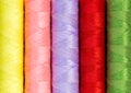 Close up colorful thread spools used in fabric and textile indus