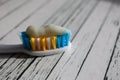 Close up of colorful toothbrush with toothpaste close up macro on wooden table Royalty Free Stock Photo