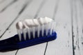 Close up of colorful toothbrush with toothpaste close up macro on wooden table Royalty Free Stock Photo