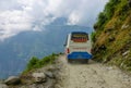 CLOSE UP: Colorful tourist bus drives along a scenic road in the green mountains