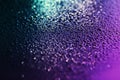 Close up of colorful water drops on the black metal. Royalty Free Stock Photo