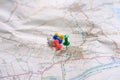 Close-up of coloured pins seen on a paper map of rural England.