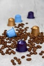 Close up of colourful coffee capsules with roasted grains on concrete background Royalty Free Stock Photo