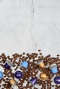 Close up colourful coffee capsules with some roasted grains on concrete Royalty Free Stock Photo