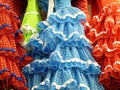 Close up of colourful, frilly, flamenco dresses for sale hanging in shop, Madrid, Spain Royalty Free Stock Photo