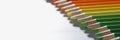 Colourful pencils set perfectly arranged in line on white surface Royalty Free Stock Photo