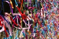 Colourful strings of ribbon tied to a fence. Royalty Free Stock Photo