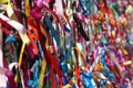 Colourful strings of ribbon tied to a fence. Royalty Free Stock Photo