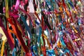 Colourful strings of ribbon tied to a fence. Royalty Free Stock Photo