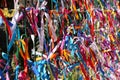 Colourful strings of ribbon tied to a fence. Royalty Free Stock Photo