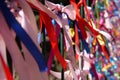 Colourful strings of ribbon tied to a fence. Royalty Free Stock Photo