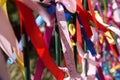 Colourful strings of ribbon tied to a fence. Royalty Free Stock Photo