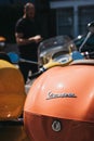 Close up of a colourful Vespa motorbike parked by a house in Bar